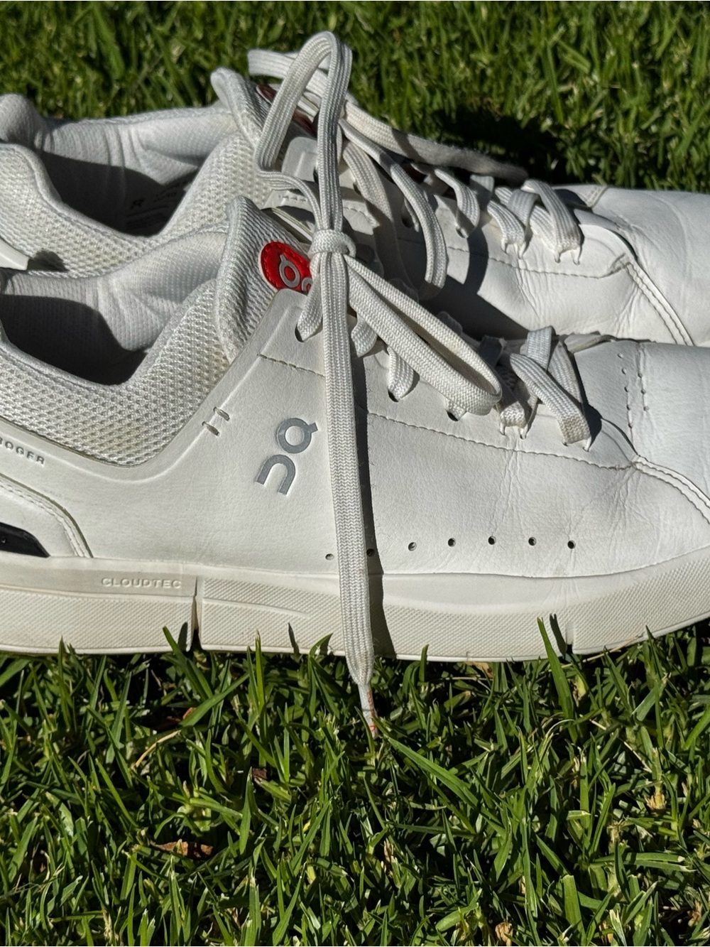 On Running White Leather Sneakers with Small Red Tongue Accent
